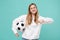 Smiling young woman girl football fan in casual white hoodie isolated on blue turquoise background. Sport leisure