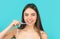 Smiling young woman with healthy teeth holding a tooth brush. Young beautiful girl holding a toothbrush. The concept of