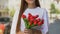 Smiling young woman holding red tulips hand, international women day celebration