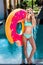 smiling young woman inflatable ring in shape of donut