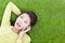 Smiling young woman listening with cell phone on grassland