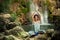 Smiling young woman practice yoga outdoor on the rocks by the wa