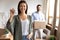 Smiling young woman satisfied customer showing keys, moving day