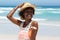 Smiling young woman with seashell at the beach