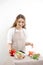 Smiling young woman serving fresh salad on plate Happy smiling cute woman cooking fresh healthy vegan salad at home with