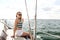 Smiling young woman sitting on yacht deck