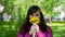 Smiling Young Woman Sniffing Yellow Dandelions
