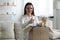 Smiling young woman stack clothes in box recommend donating