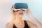 Smiling young woman using the VR goggles