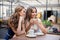 Smiling young women drinking coffee at street cafe