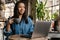 Smiling yuong african woman working on laptop