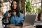 Smiling yuong african woman working on laptop