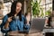 Smiling yuong african woman working on laptop