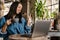 Smiling yuong african woman working on laptop