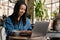 Smiling yuong african woman working on laptop