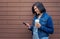 Smilling brunette woman with smartphone