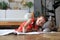 Smilling happy girl lying on warm floor with a toy elephant near to her enjoying creative activity