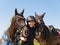 Smilling young girl happy after win the showjumping competition with her two horses