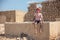 Smilling young man sitting at the acient ruins of the persian village