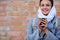 Smilling young woman with cup coffee