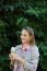 Smilling young woman with ice cream in nature