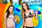 Smilng women in bikini standing near water slide in the aqua park