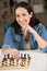 Smily woman playing chess