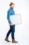 Smling young man holding blank board over white background