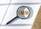 SMM acronym. Social media marketing through magnifying glass