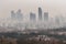 smoggy city view, with buildings and residences visible through haze