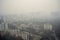 smoggy city view, with buildings and residences visible through haze