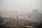 smoggy city view, with buildings and residences visible through haze