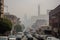 smoggy cityscape with towering smokestacks and heavy traffic