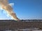 Smoke billowing from a controlled fire at a landfill site in winter in Minnesota