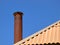 Smoke chimney on slate roof