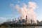 Smoke from Coal-Fired Power Plant with blue sky in morning day