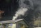 Smoke emanating from a wood burning stove in a small house