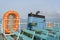 Smoke from ferry boat flue during sea with sunlight, sea water and clear sky in background, Thailand