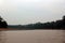 Smoke from a fire in the Amazon rainforest along the Tambopata River in Peru at sunrise