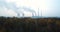 Smoke over forest and power plant.