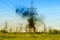 Smoke over the high-voltage power line. A fire in the city`s electricity supply network. Problems with power supply of the