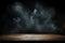 Smoke rises from dark wooden table against a shadowy backdrop