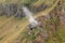 Smoke rises from a volcanic flue in the Batur Crater. Geological formation in active volcano with volcanic chimney.