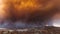 Smoke from Sand brush fire covering Santa Clarita cityscape at sunset in California