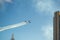 Smoke squadron planes perform acrobatics between residential buildings