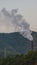 Smoke stack and cell phone tower in rural China