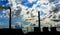 Smoke stacks at coal burning power plant, industrial silhouette.