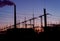 Smoke stacks at coal burning power plant, industrial silhouette.