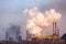 smoke stacks in a working factory emitting steam