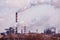 smoke stacks in a working factory emitting steam